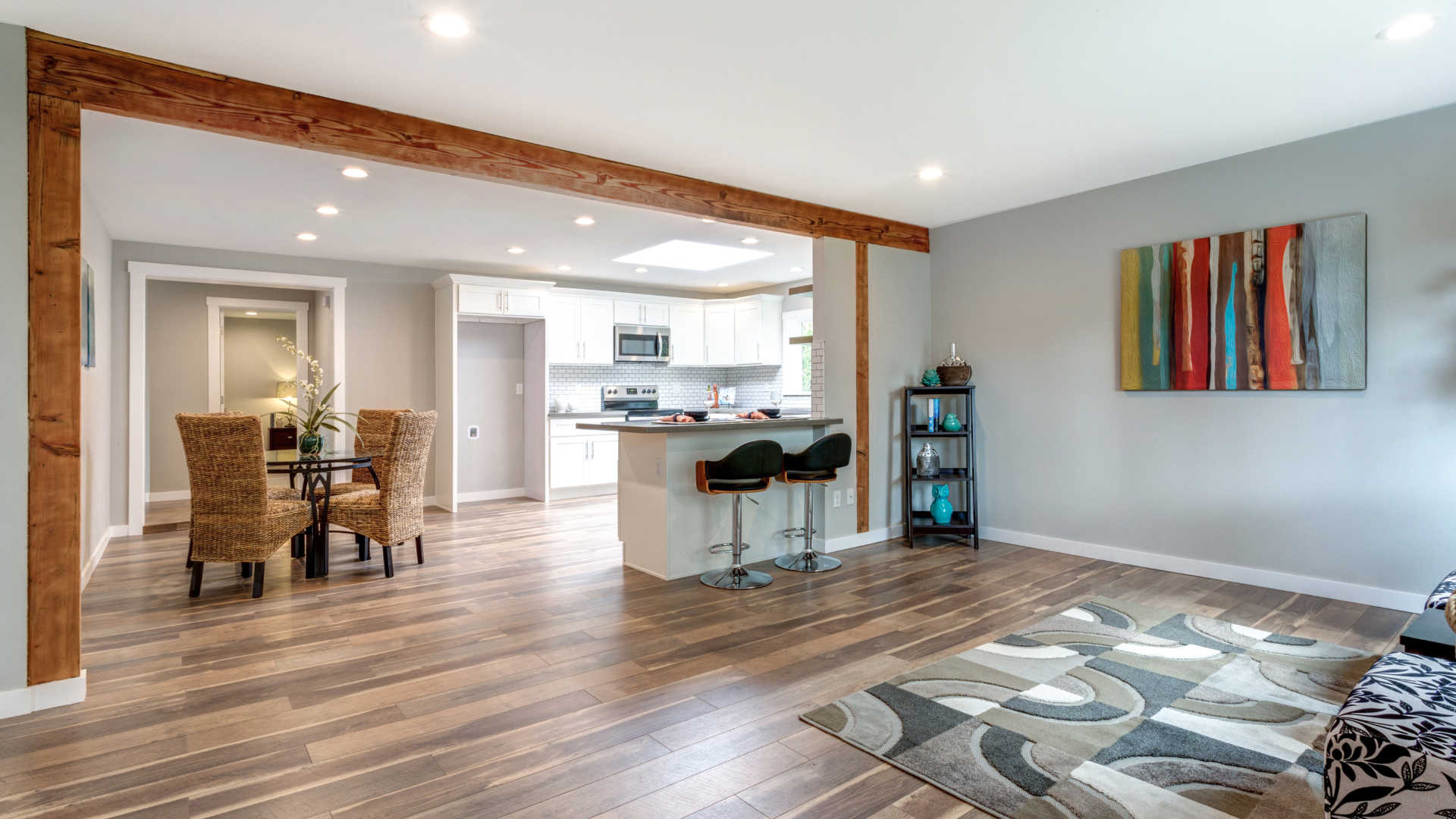 Spacious living room with mixed hardwood floors. 